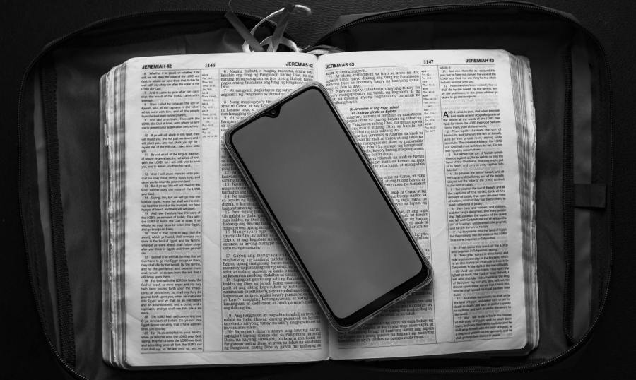 smartphone placed on opened dictionary in case bag