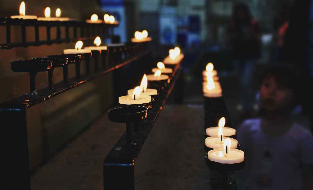 white tealight candles lit during nighttime