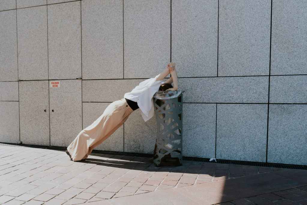 woman exercising on a garbage bin
