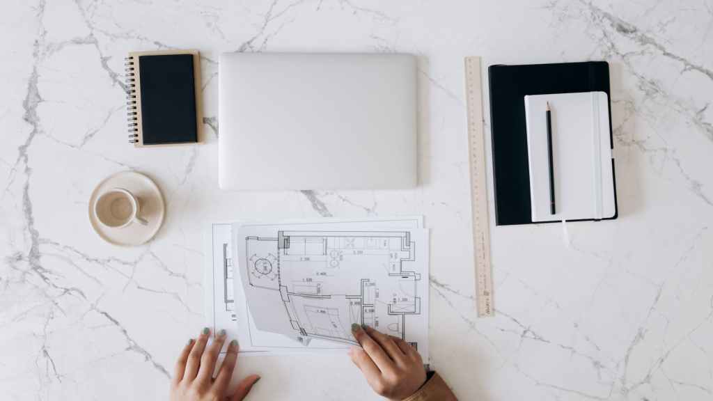 an architect s work table with tools and blueprints