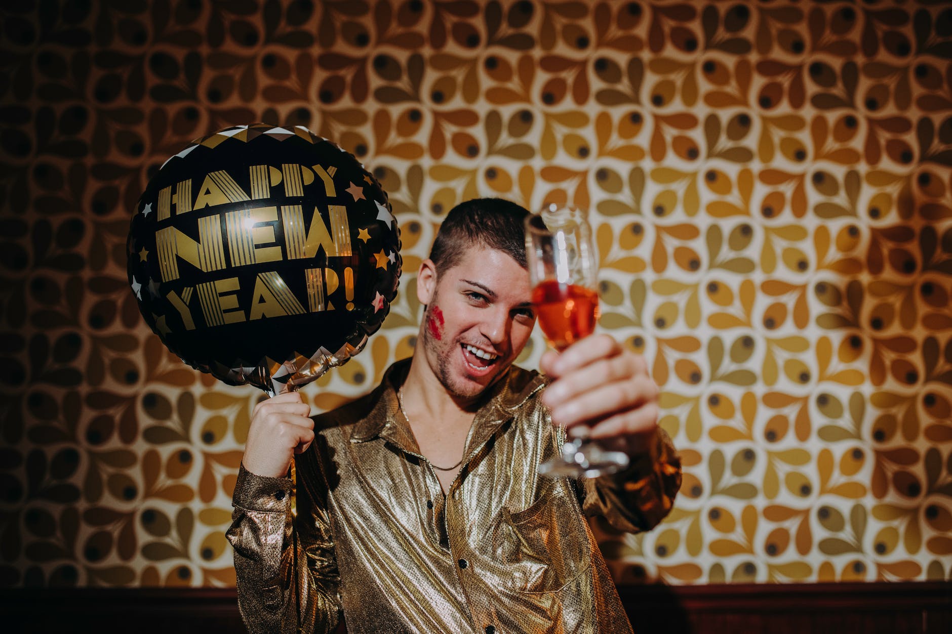man holding champagne glass and balloon